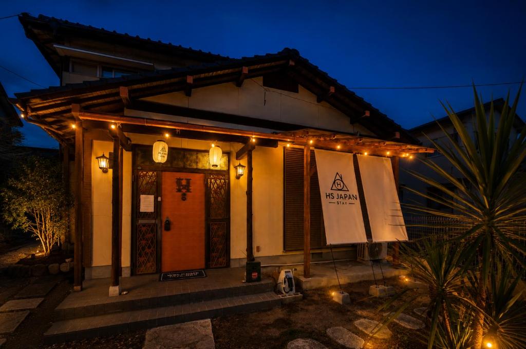 a small house with lights on it at night at HS Japan STAY 瀬戸内 in Takamatsu