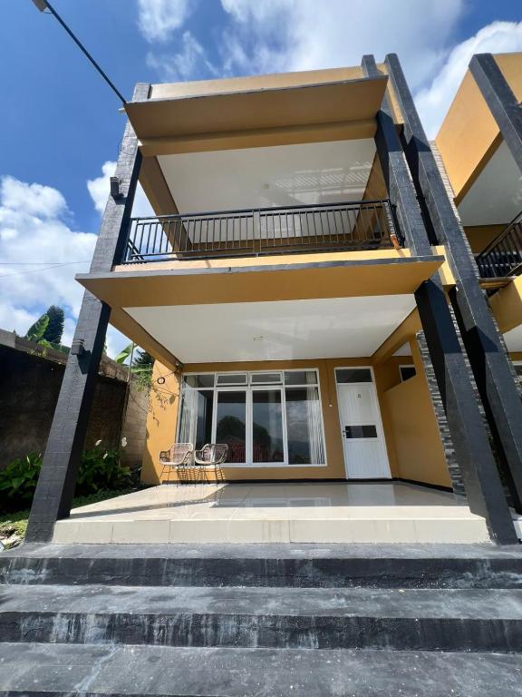 a house with stairs leading up to it at new pratama in Sampal 2