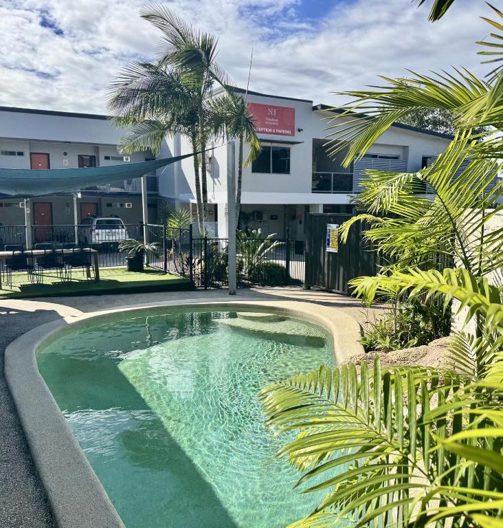 a swimming pool in front of a building at Nambour Heights Motel in Nambour