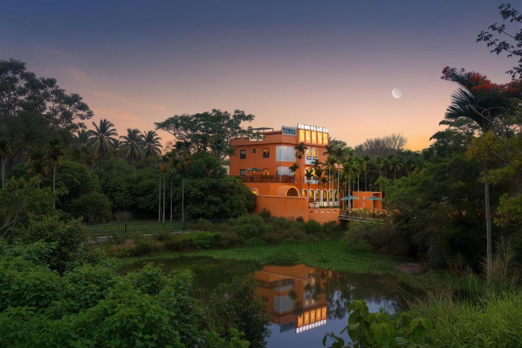 an orange house in the middle of a river at Nanxiang Shushan Hotel in Sanya