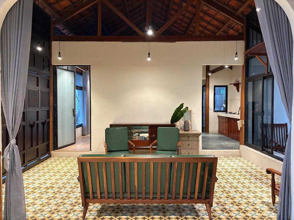 an open living room with a couch and chairs at Half Village, Nha Trang in Nha Trang