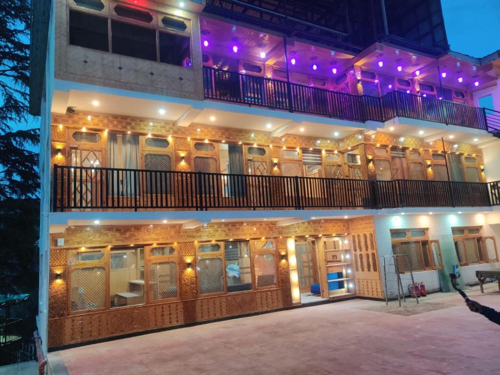 a building with purple lights on top of it at Bhaderwah Resorts Pvt Ltd in Dranga