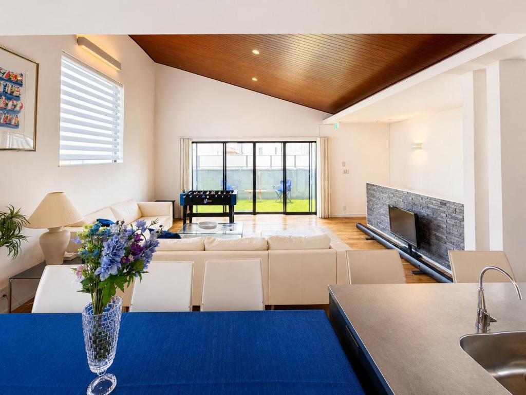 a living room with a vase of flowers on a table at Rayful Hayama in Hayama