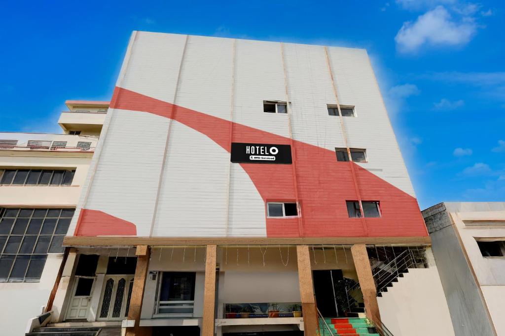 a building with a sign on the side of it at Hotel O Benz Circle Crossway Vijayawada Formerly Akshaya Elite in Vijayawada