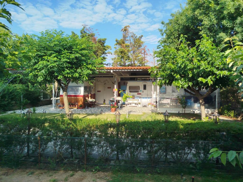 a house being remodeled with trees in the yard at DamAnda mare in Nea Potidaea