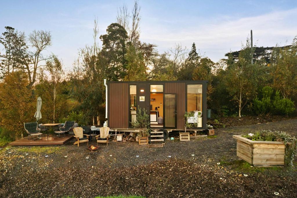 a tiny house in the middle of a yard at Belrose Estate by Tiny Away in Dumbalk