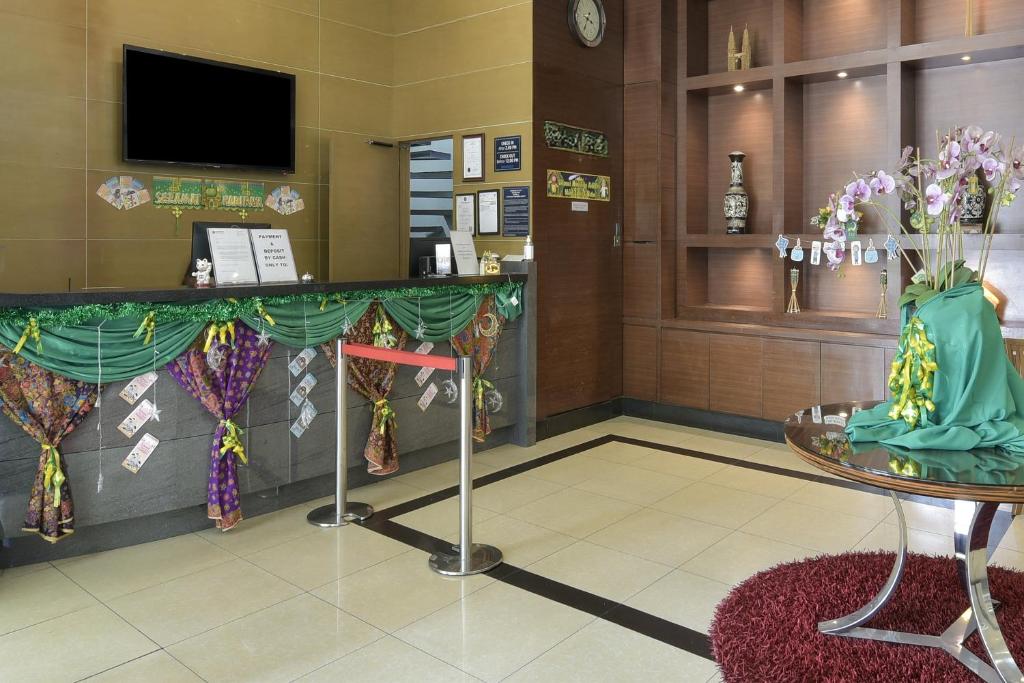 The reception lobby has a decorated front desk and a floral display beside it.