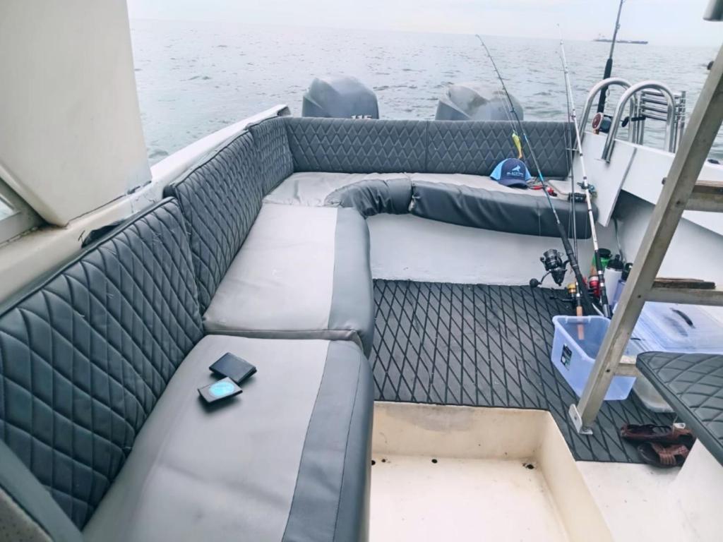a seat on the back of a boat on the water at Tour Full Day Taboga in Panama City