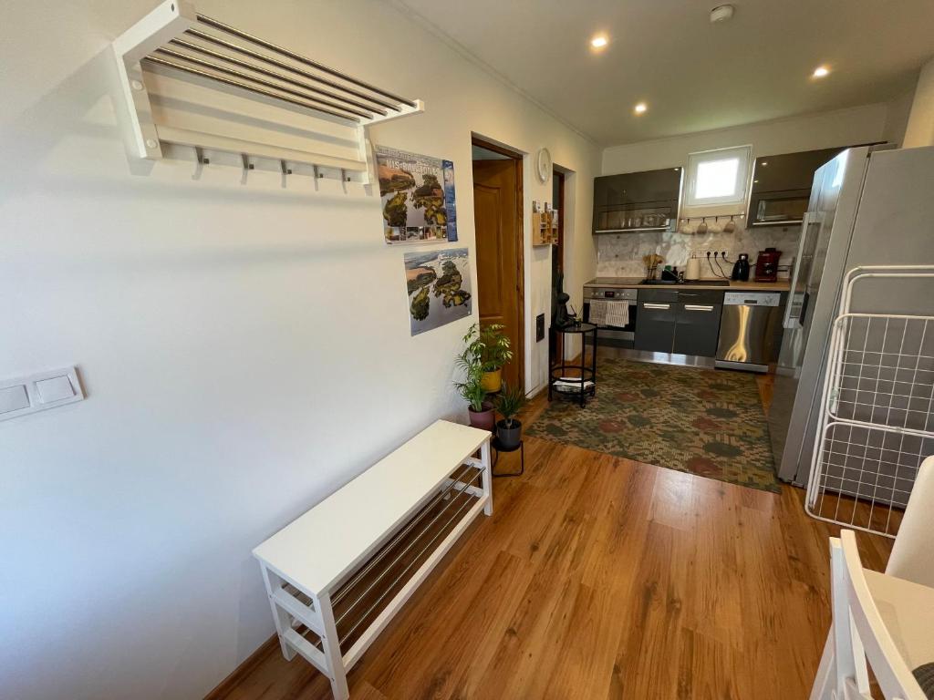 a living room with a bench and a kitchen at Gellénia in Balatonberény