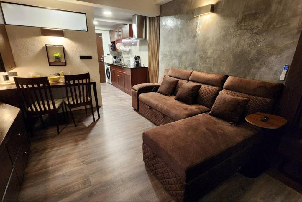 a living room with a couch and a table at Resort-Style 1BR-Epic Pool View-Walk to Beach in Bophut