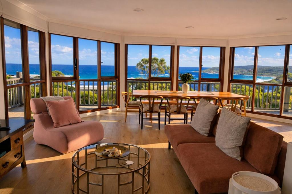 a living room with a couch and a table at Grandview Holiday Beach House in Gracetown