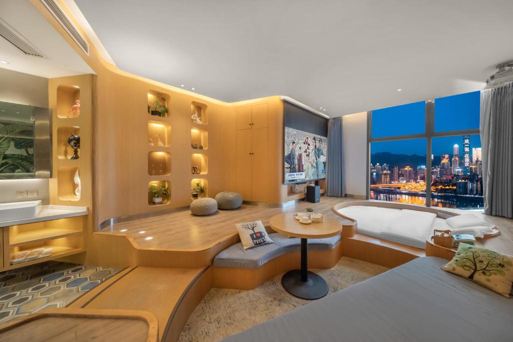 a living room with a view of a city at ChongQing BackHome Riverview Hotel in Chongqing