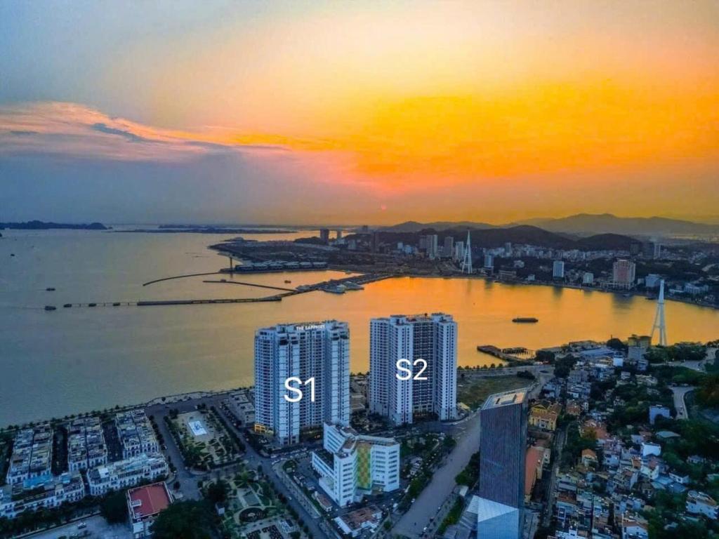 an aerial view of a city with a sunset at Sapphire Premium Studio Hạ Long in Ha Long