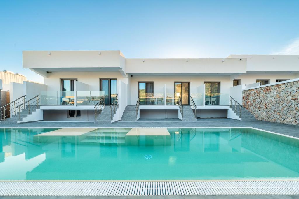 a house with a swimming pool in front of it at Prasonisi Lighthouse Studios in Prasonisi