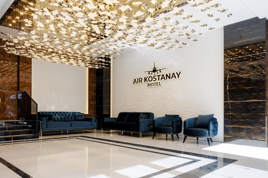 a lobby of a luxury hotel with chairs and lights at Air Kostanay in Kostanay