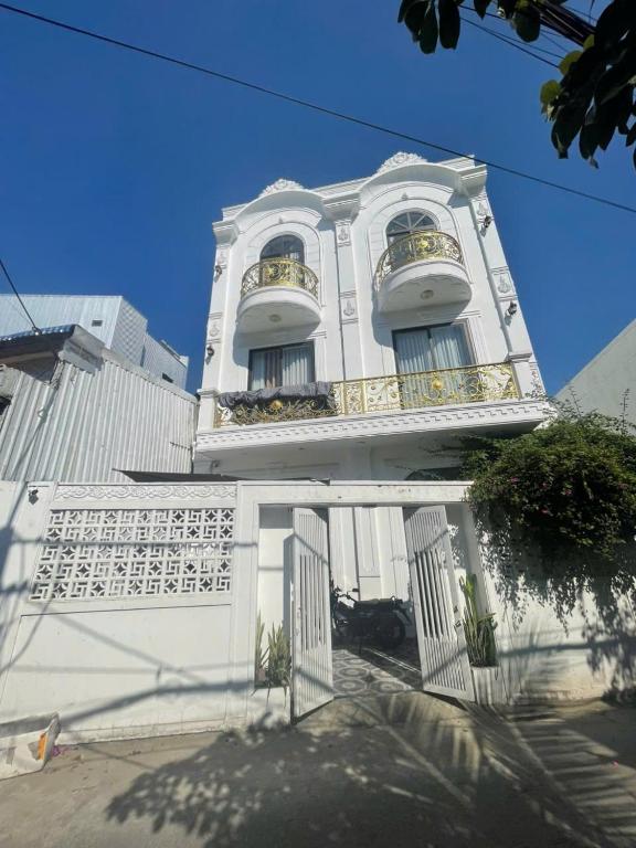 a white building with two balconies on top of it at Lya Homestay CMT8 Da Nang in Danang