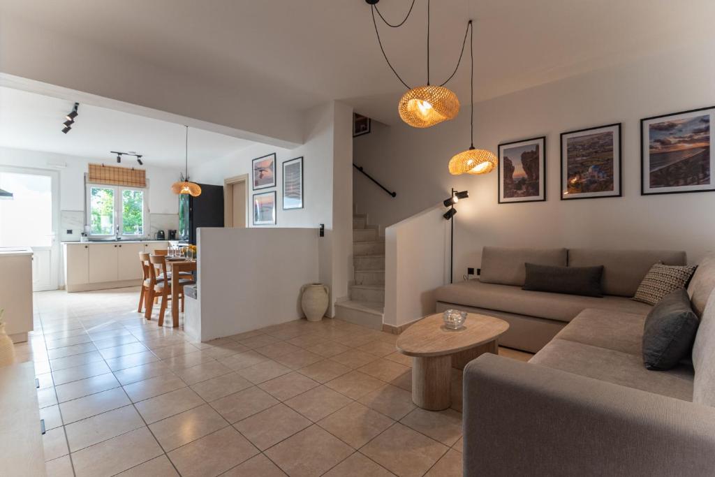 a living room with a couch and a table at Gallery Home in Kardamaina