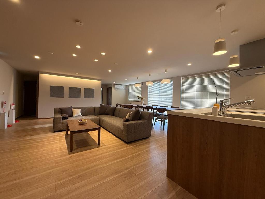 a kitchen and living room with a couch and a table at Fubuki Kimobetsu in Abuta