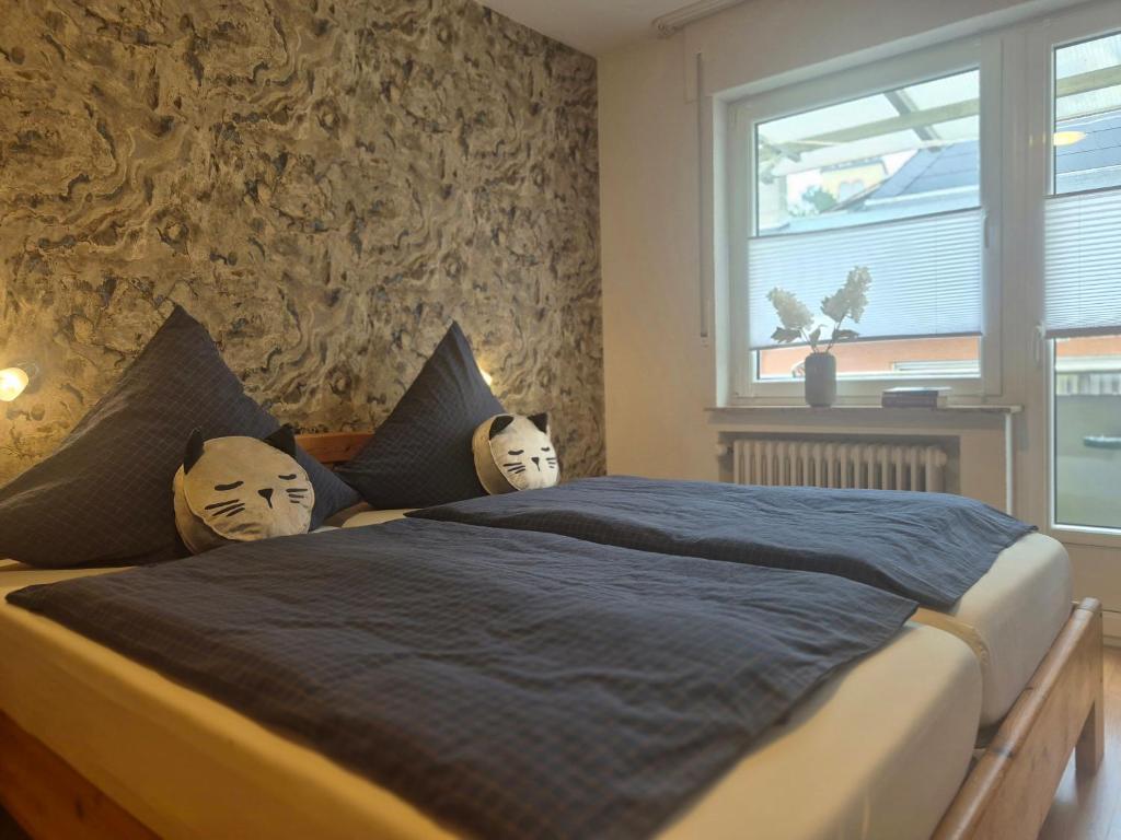 a bedroom with a large bed with masks on the pillows at Gästehaus Manfred Christoffel in Kröv