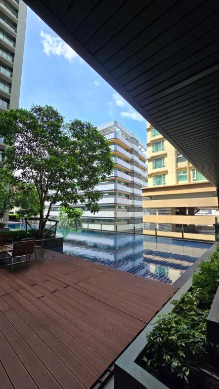 a view of a building from a deck with a tree at ELiTE 61 THONGLOR in Sathani Khlong Tan