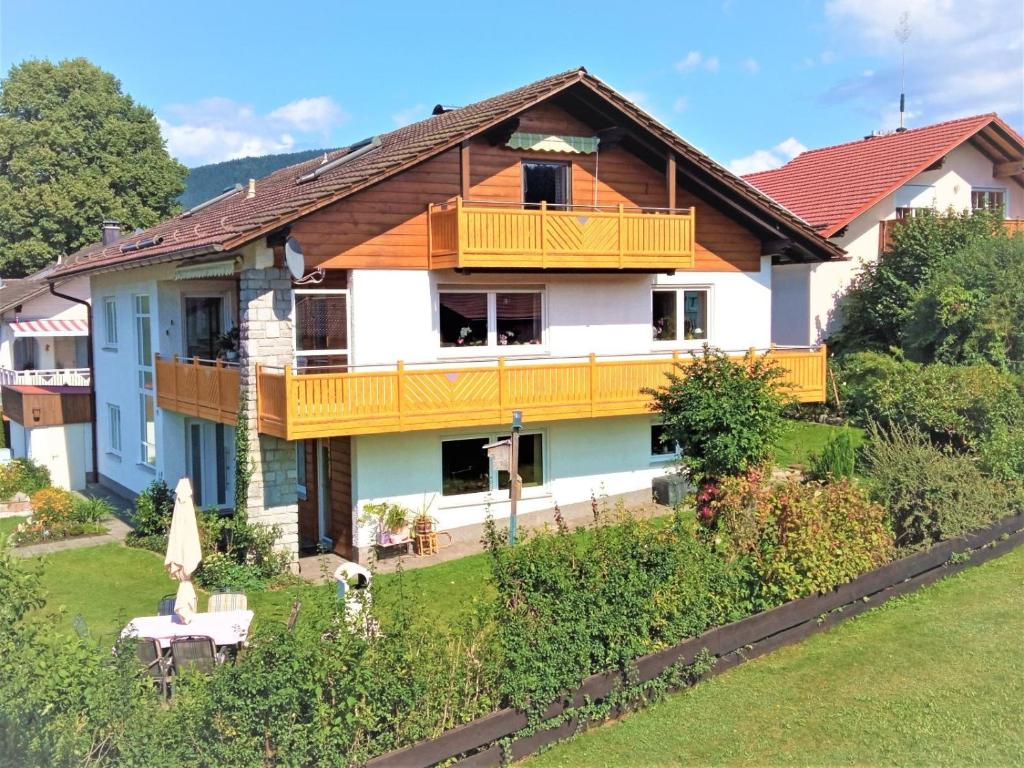 a house with a balcony and a yard at Fischer Willi in Bad Koetzting
