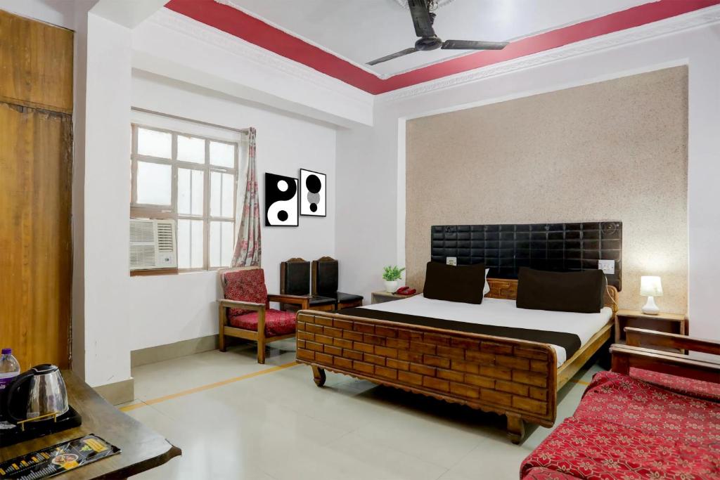a bedroom with a bed and a chair in it at Hotel Welcome Palace in Patna