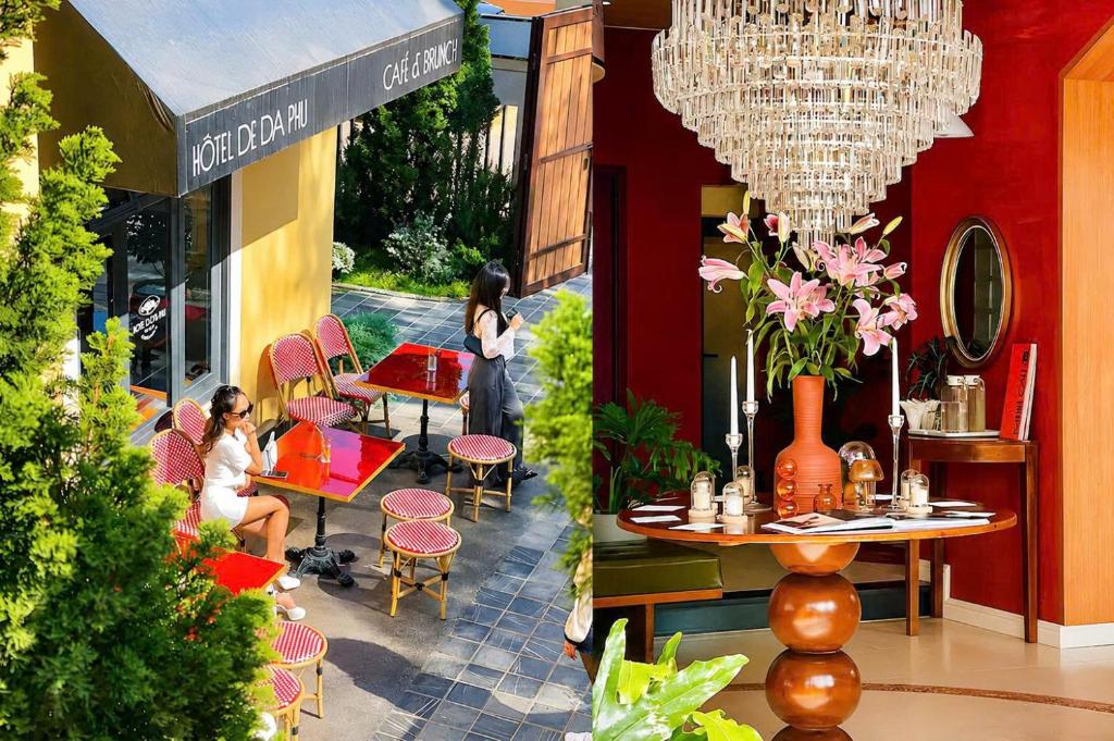 a woman sitting at a table outside of a store at Hôtel De Da Phu in Da Lat