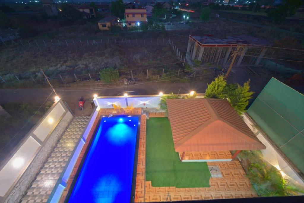 an overhead view of a swimming pool at night at I EMPYREAN STAYS ll MYSTICAL STONE VILLA ll 4BHK II AC II PRIVATE POOL II in Lonavala