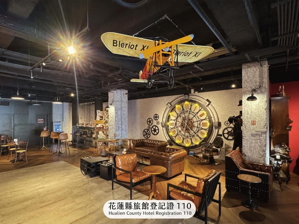 a room filled with furniture and a plane on the wall at Mazor Hotel Hualien Linsen in Hualien City