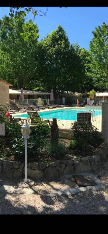 a swimming pool with a light pole in front of it at Chalet in Tourrettes