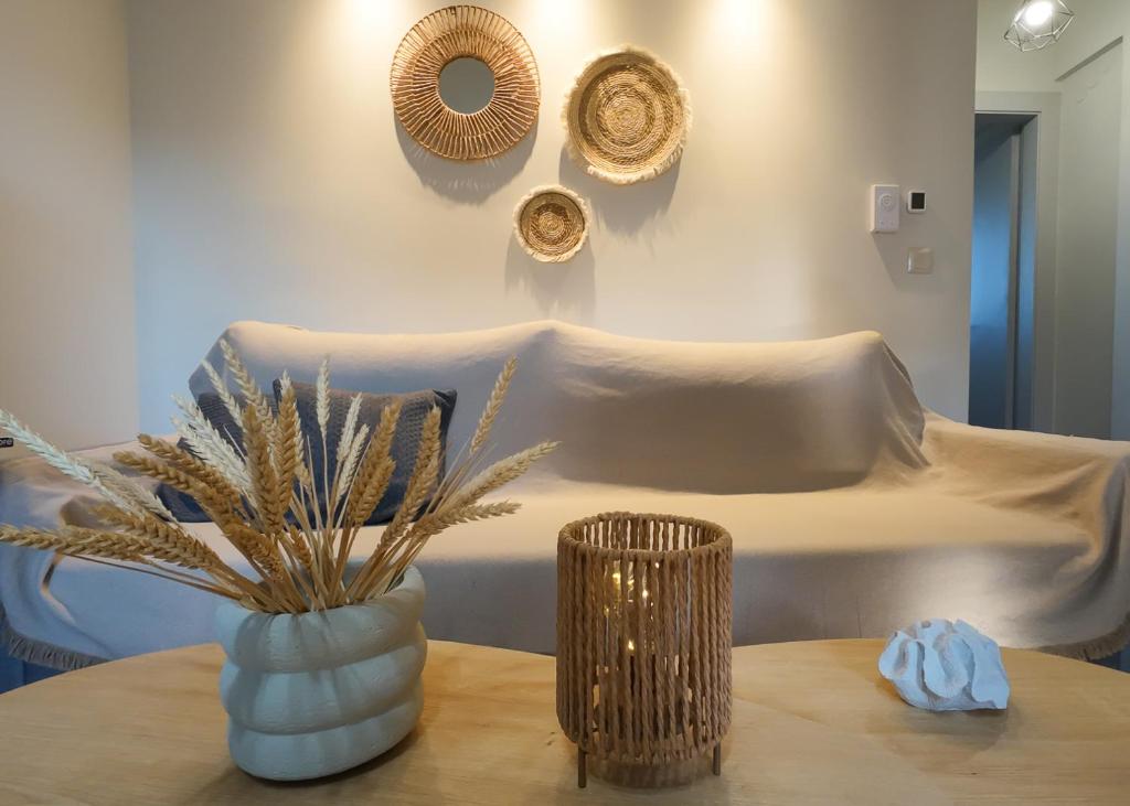 a room with a bed and a table with a vase at Kleopatra's Apartments in Chios