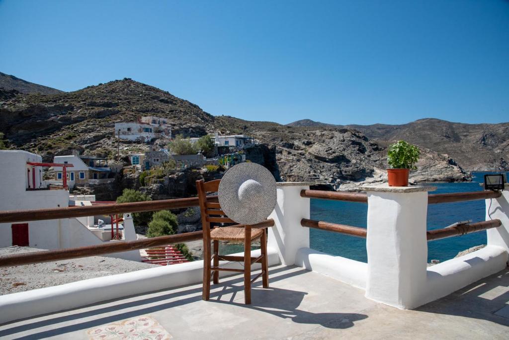 a chair on a balcony with a view of the ocean at Aegean Whisper Koumelas in Mamádhos