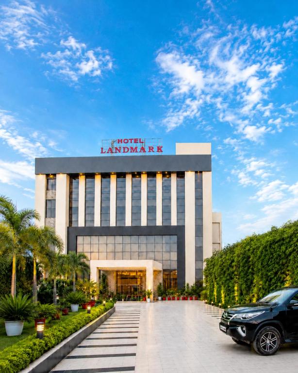 a building with a car parked in front of it at Landmark, Rewa - AM Hotel Kollection in Rewa