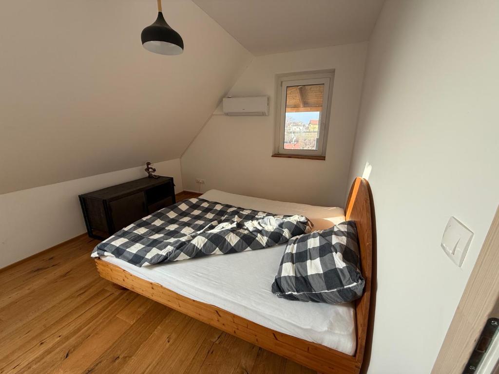 a bedroom with a bed with black and white pillows at Danube House in Mohács