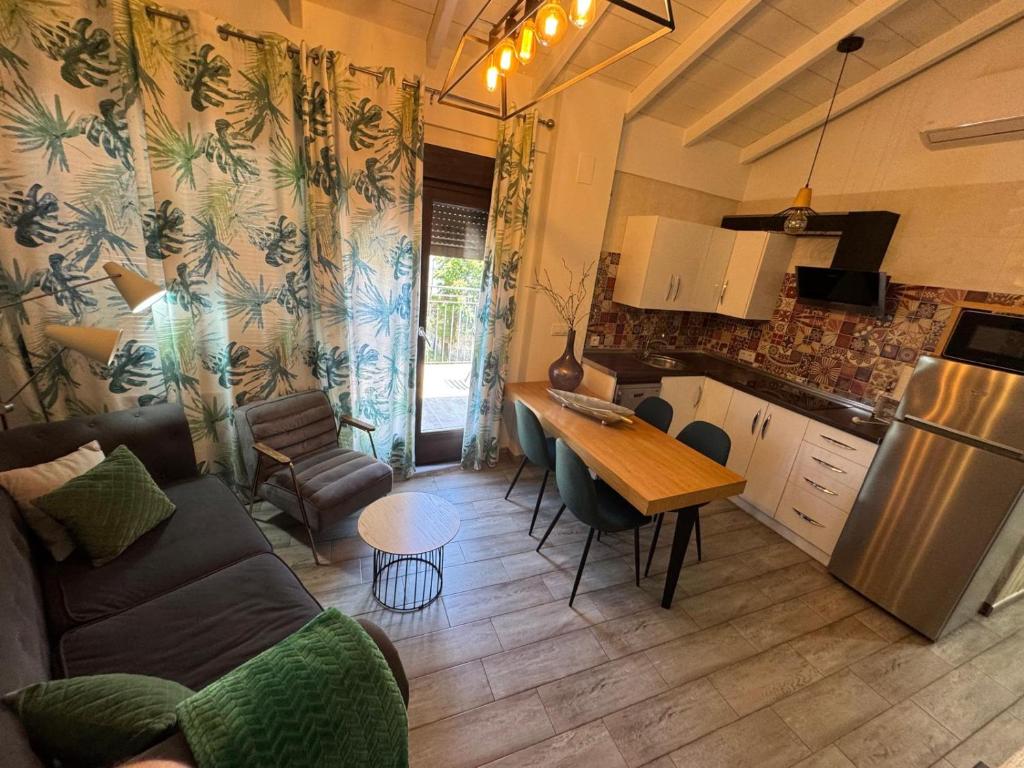 a kitchen and living room with a couch and a table at Casa del Agua in Cazorla