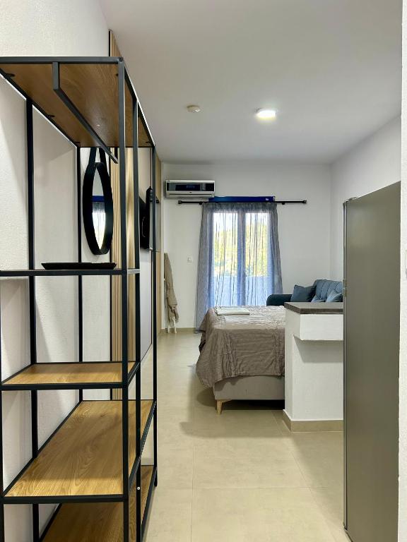 a bedroom with a bed and a book shelf at Salt & Sea in Sarti