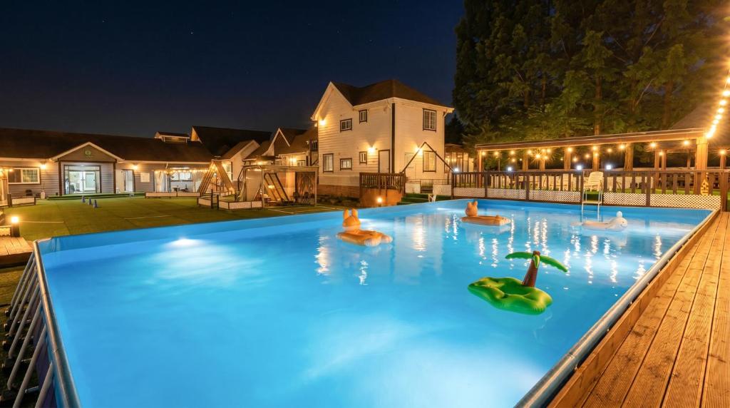 a swimming pool at night with toys in the water at Gapyeong Dangdangi Pet Pension Green in Gapyeong