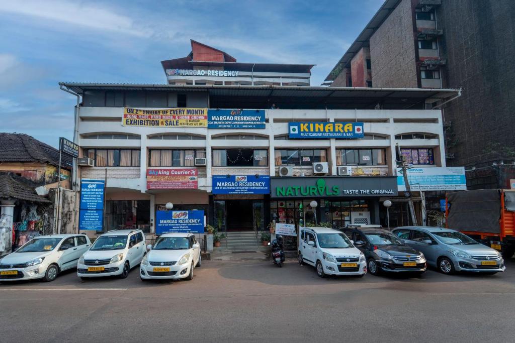 a building with cars parked in front of it at Margao Residency in Madgaon