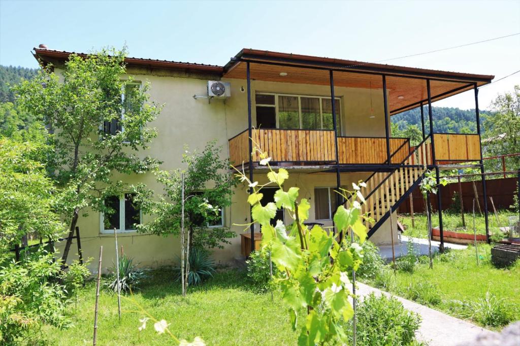 a house with a deck and a balcony at MAKO in Racha in Ambrolauri
