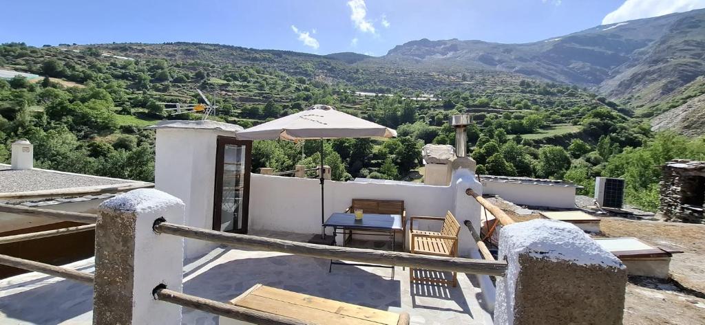 a view from the roof of a house with an umbrella at Casa Pura de Trevélez in Trevélez