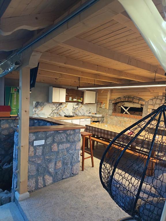 a kitchen with a table and a stone wall at Stefke 2 in Lučani