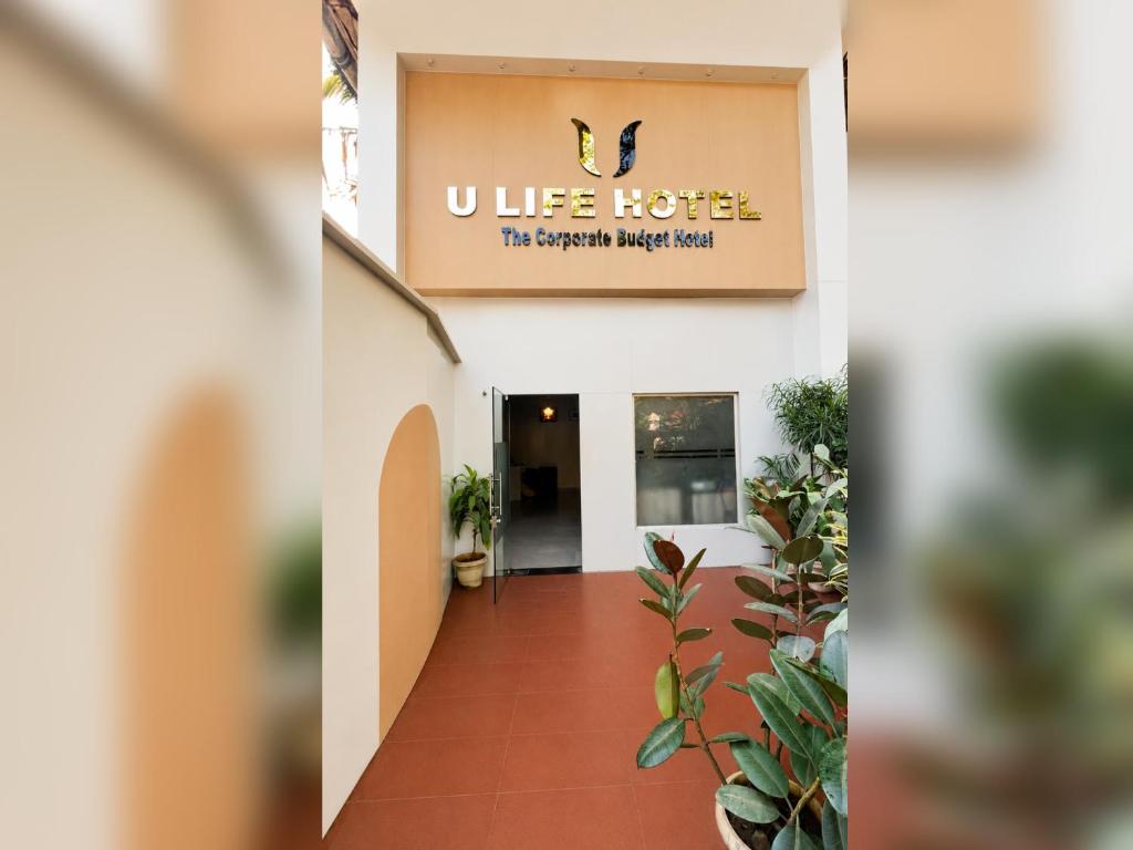 a lobby of a hotel with a sign on the wall at U LIFE HOTEL in Mumbai
