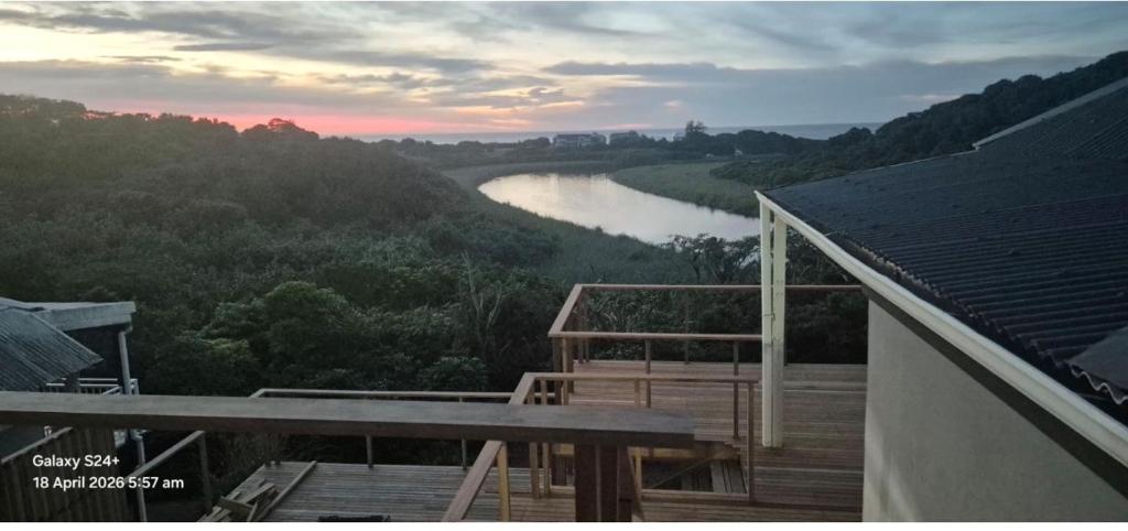 a view of a river from a deck with a view at Beautiful Lagoon House in Blythedale