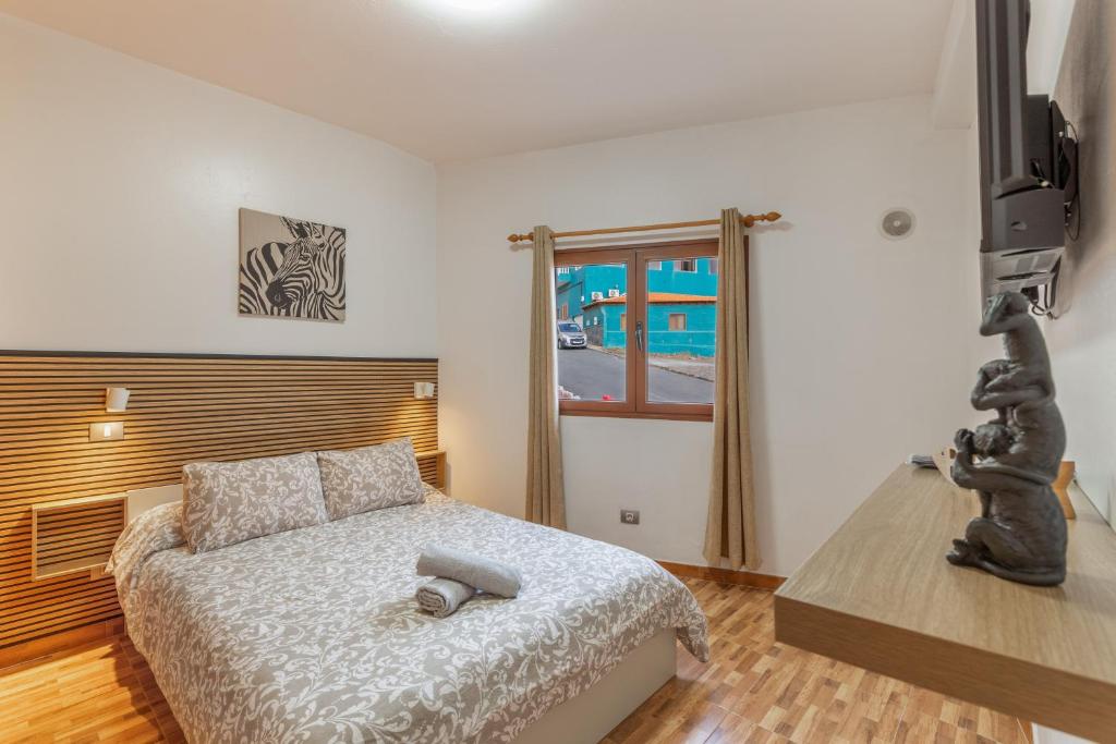 a bedroom with a bed and a television in it at Las Sirenas 2 in Las Palmas de Gran Canaria