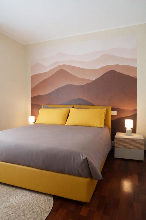 a bedroom with a bed with a mountain mural on the wall at Fiuggi Terme Bonifacio Apartment in Fiuggi