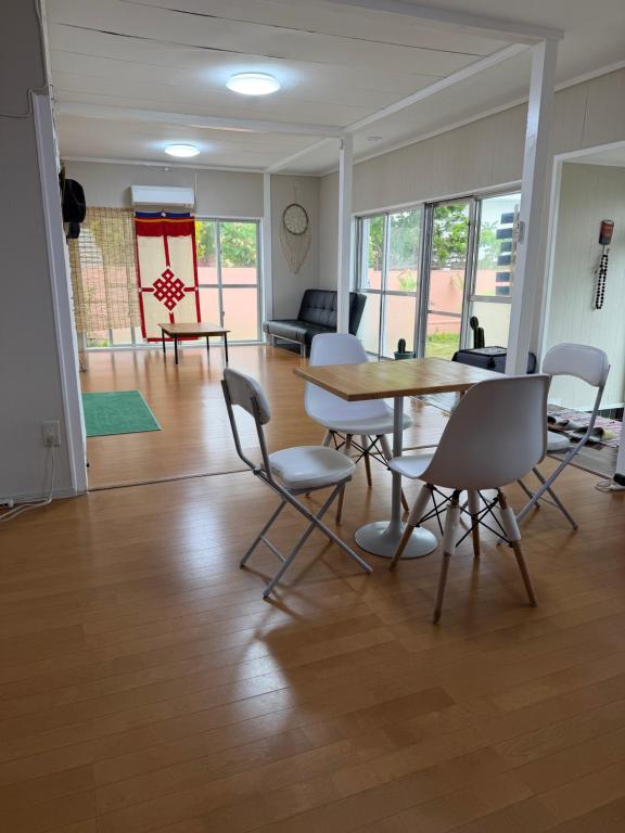 a dining room with a table and chairs in a room at MIYARA GARDEN House in Ishigaki Island
