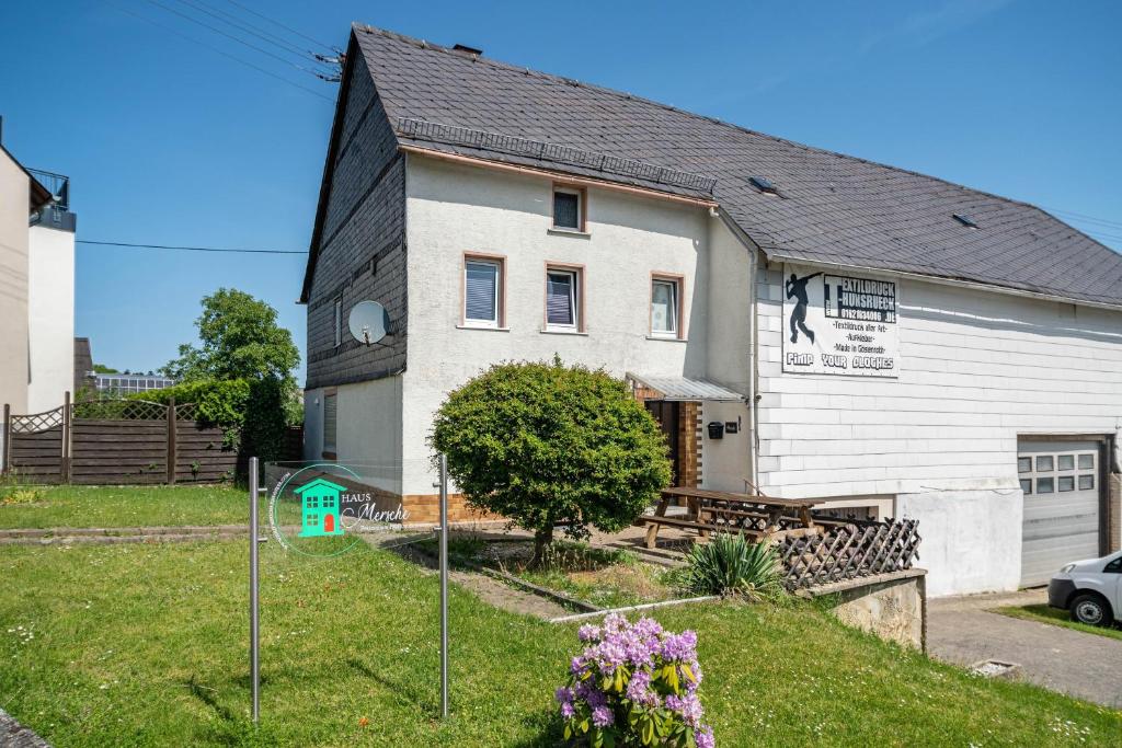 a white building with a black roof at Haus Mersche in Gösenroth