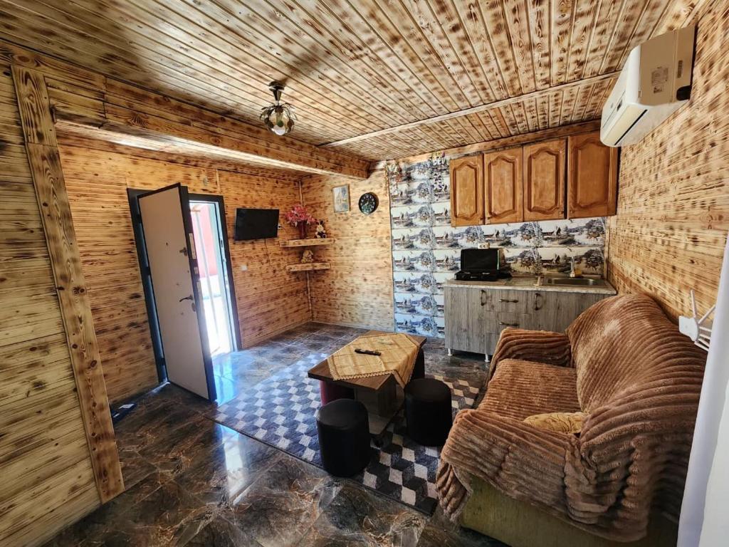 a living room with a couch and a table at Teo's cottage in Maradidi