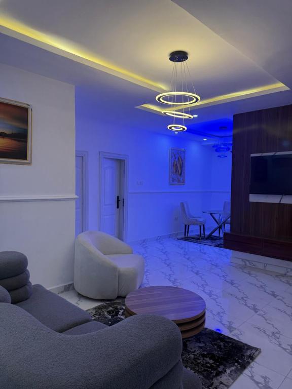 a living room with a couch and a table at Pristine Residences Premium 2 Bedroom Apartment Ajah Lagos in Lekki