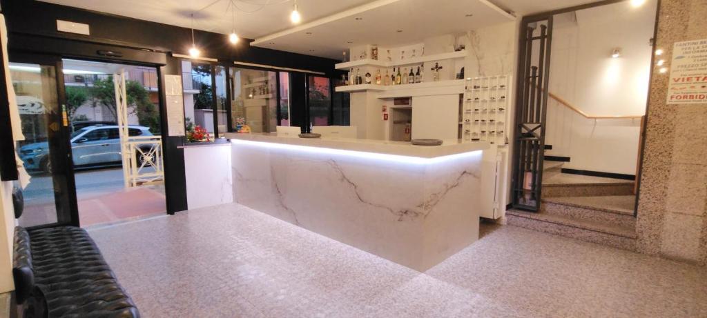 a store with a white counter in a room at Hotel Marbella in Cervia